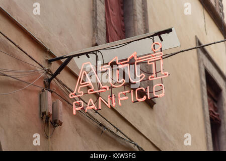 The red neon sign for the Atti Panifico bread and delicatessen shop in Bologna Italy Stock Photo