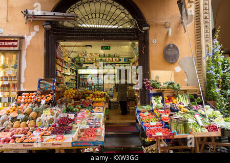 A fruit and vegetable shop or greengrocer  with a display of fruit and veg outside on the street in Bologna Italy Stock Photo