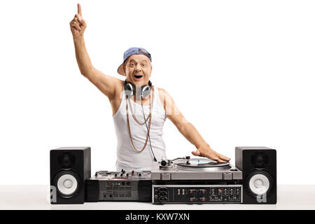 Cheerful old DJ playing music on  a turntable and holding his finger up isolated on white background Stock Photo