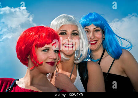 The Netherlands. Amsterdam. Annual festival on 27 april called Koningsdag (Kingsday), celebrating the king's birthday. Women with wigs in national col Stock Photo