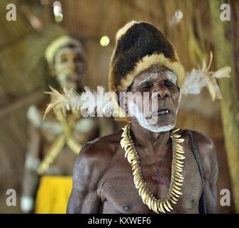 Portrait of a man from the tribe of Asmat people with ritual face painting on Asmat Welcoming ceremony. Stock Photo