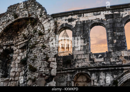 Silver Gate at the Palace of the Emperor Diocletian in Split Croatia as the sun sets and light hits the tower of Cathedral Saint Domnius Stock Photo