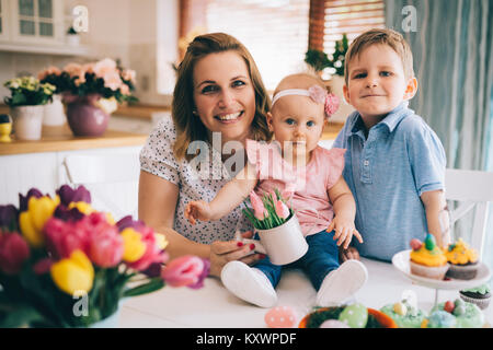 Happy and loving mother and her kids preparing home decoration Stock Photo