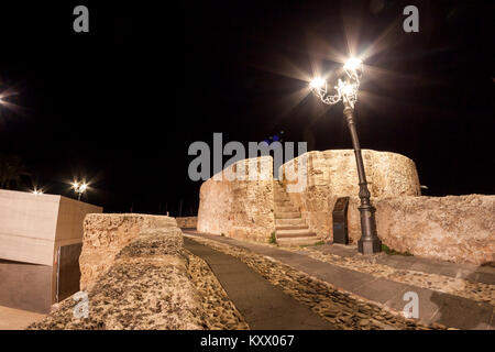 Ancient city walls on a wet autumn night. Alghero, Sardinia. Italy Stock Photo