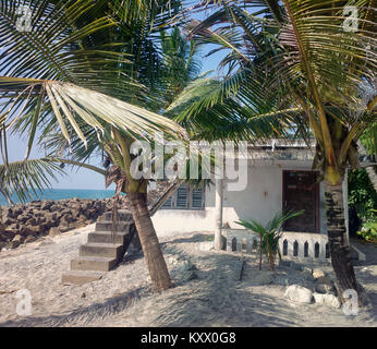 Old small cottage on shores of Arabian sea, opened right on beach. Kerala Stock Photo