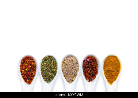 Top view of assorted aromatic spices in ceramic spoons isolated on white   Stock Photo