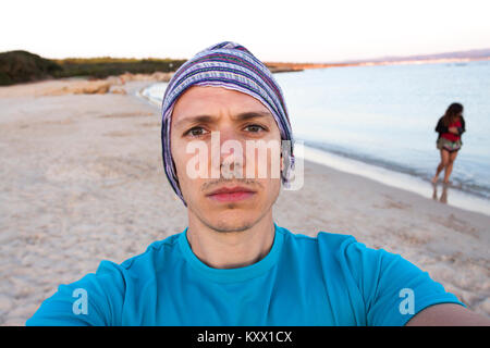 Portrait of a man wild and woman in background. Alghero, Sardinia. Italy Stock Photo