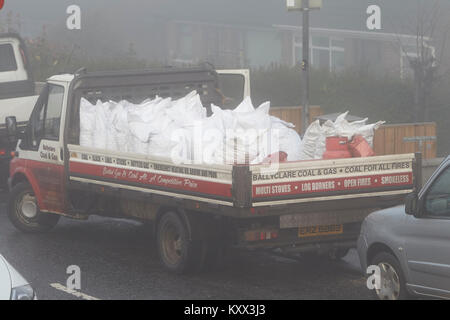 van delivering coal and solid fuel on a foggy day in the uk Stock Photo