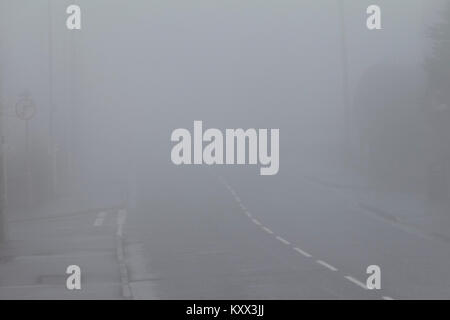 empty road without vehicles in dangerous driving conditions on a foggy day in the uk Stock Photo