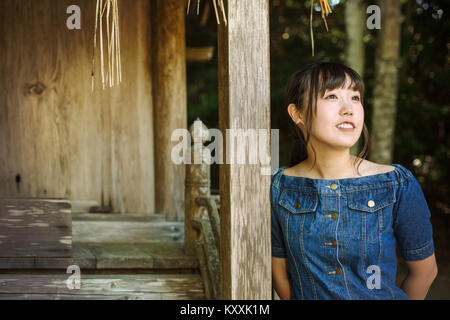 Young woman wearing blue dress at Shinto Sakurai Shrine, Fukuoka, Japan. Stock Photo