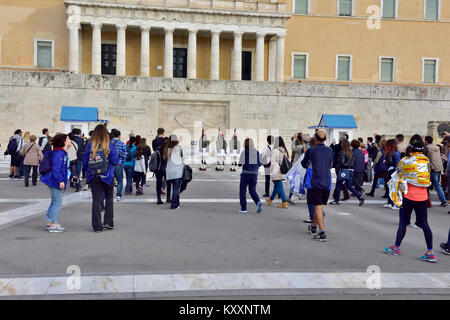 Tourists watching the changing of the Evzones guard ceremony in front of Greek Tomb of Unknown Solder by parliament building Stock Photo