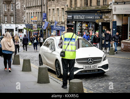 Paking Attendant issuing penalty ticket. Stock Photo