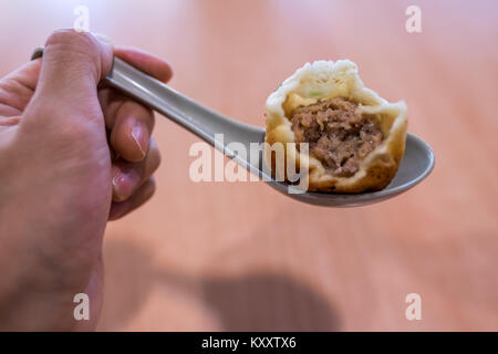 Inside of a Sheng Jian Bao - Shanghainese pan fried dumpling - Pork filling Stock Photo