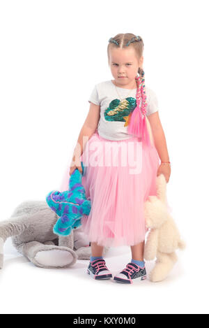 little girl posing together with big toys Stock Photo