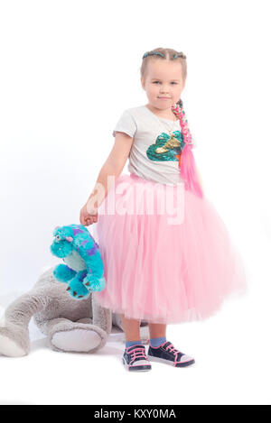 little girl posing together with big toys Stock Photo