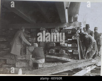 The image shows a destroyed reinforced concrete bridge in Brzezany, with a hoisting crane in operation. This photograph highlights the destructive impact of warfare on infrastructure and the use of machinery for post-conflict rebuilding. Stock Photo