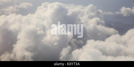 Clouds white and grey on dark blue sky background. Aerial photo from plane's window Stock Photo