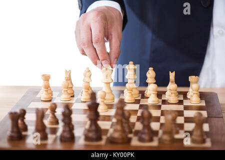 partial view of businessman holding chess figure isolated on white Stock Photo