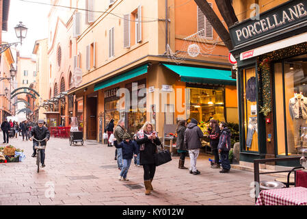 Bologna, Italy - December 2017: People walking in Via Clavature, a famous street full of traditional stores and restaurants in the characteristic medi Stock Photo