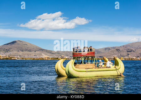 PUNO, PERU - MAY 14, 2015: Unidentified tourists in Totora boat, Titicaca lake near Puno, Peru Stock Photo