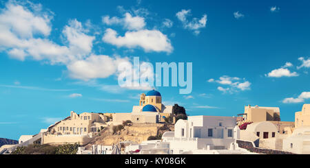 View over Oia village, Santorini island, Greece, with beautiful local church in the foreground. Panoramic image, space for your text. Stock Photo