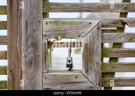 padlock on wooden gate Stock Photo