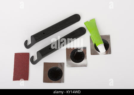 Bike tyre tube puncture repair tool kit, set of tools  for repairing  punctured tube, isolated on white background, studio photo. Stock Photo