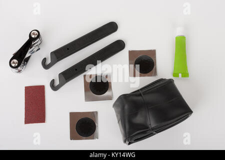 Bike tyre tube puncture repair tool kit, set of tools  for repairing  punctured tube, isolated on white background, studio photo. Stock Photo