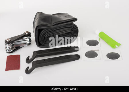Bike tyre tube puncture repair tool kit, set of tools  for repairing  punctured tube, isolated on white background, studio photo. Stock Photo
