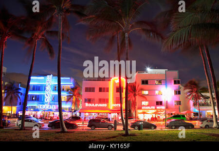 Ocean Drive Art Deco buildings illuminated at dusk in Miami Beach