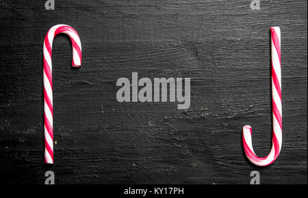 frame of two sugar candies. On the black chalkboard. Stock Photo