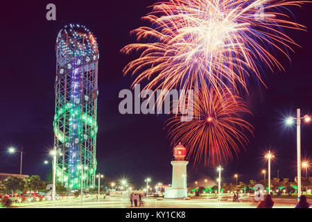 Batumi, Adjara, Georgia. Festive Salute During Celebration Of Georgia's Independence Day Over Illuminated Alphabet Tower And Pitsunda Lighthouse At Pr Stock Photo