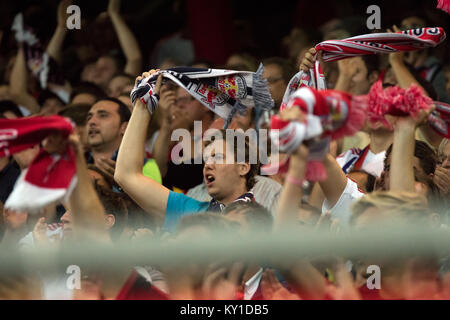 The football fans from FC Red Bull Salzburg support the home team the whole match at the Red Bull Arena when the local heroes met Malmö FF in the first leg of the last Champions League qualifications round. Gonzales Photo/Christoph Oberschneider. Stock Photo