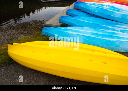 Beautiful and colorful kayaks in rows on a lake Stock Photo