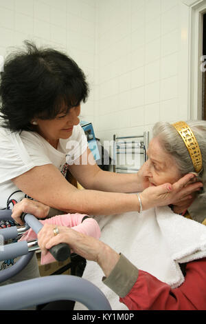 Live-in Health Care Managers give 24 hour support to elderly woman in wheelchair North London Stock Photo