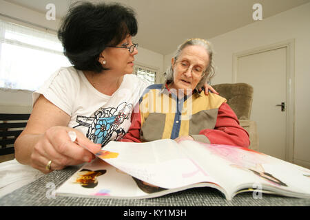 Live-in Health Care Managers give 24 hour support to elderly woman in wheelchair North London Stock Photo