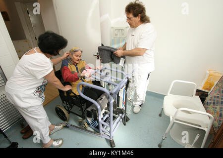 Live-in Health Care Managers give 24 hour support to elderly woman in wheelchair North London Stock Photo