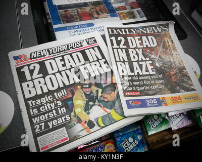 Headlines of the New York Daily News and the New York Post have identical headlines on Friday, December 29, 2017 editions reporting on the death of 12 in the worst fire the city has seen in 27 years. (© Richard B. Levine) Stock Photo