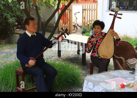 Chinese Traditional Music perform by an elderly couple in the tea Garden. Travel in Suzhou City, China in 2009 ,April 17th. Stock Photo