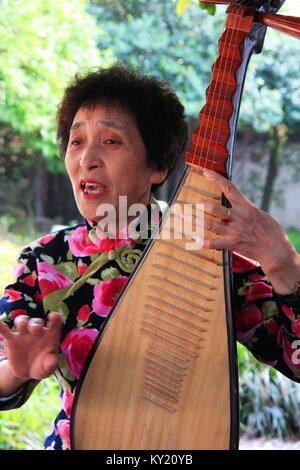 Chinese Traditional Music perform by an elderly couple in the tea Garden. Travel in Suzhou City, China in 2009, April 17th. Stock Photo