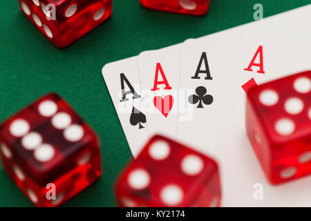 Poker cards and dice on a green background. Stock Photo