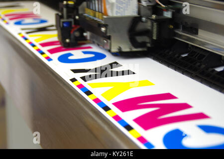 Printers printing CMYK colour test print on packaging four 4 color ...