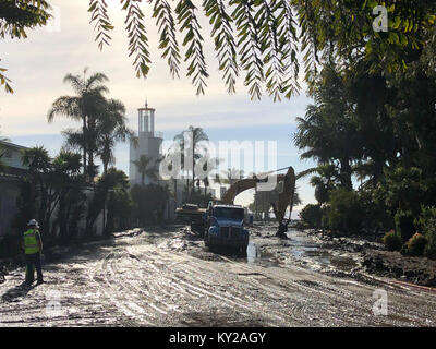 Montecito, USA. 10th Jan, 2018. This photo provided by the Santa Barbara County Fire Department shows cleanup of mud and debris in Montecito, the United States, Jan. 10, 2018. Eight people are still missing in deadly mudslides that have claimed 17 lives so far in Santa Barbara County in the western U.S. state of California, local authorities said Thursday. Credit: Mike Eliason/Santa Barbara County Fire Department/Xinhua/Alamy Live News Stock Photo