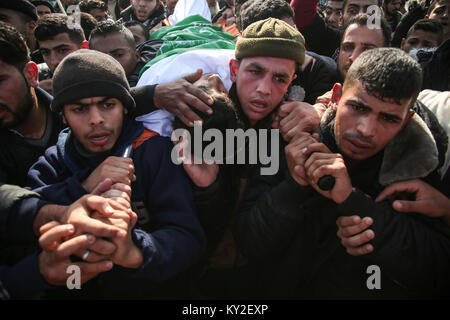 GRAPHIC CONTENT: Refugee Camp, The Gaza Strip, Palestine. January 12, 2018 - Al-Maghazi Refugee Camp, The Gaza Strip, Palestine - Funeral of Amir Abu Musaed a 16-year-old Palestinian from Al-Maghazi refugee camp in central of the Gaza Strip, Amir was shot during clashes between Palestinians and Israeli troops along the eastern Gaza border. Credit: Hassan Jedi/Quds Net News/ZUMA Wire/Alamy Live News Stock Photo