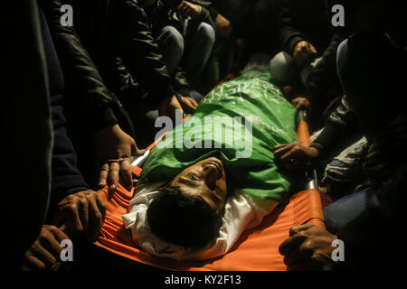 GRAPHIC CONTENT: Refugee Camp, The Gaza Strip, Palestine. January 12, 2018 - Al-Maghazi Refugee Camp, The Gaza Strip, Palestine - Funeral of Amir Abu Musaed a 16-year-old Palestinian from Al-Maghazi refugee camp in central of the Gaza Strip, Amir was shot during clashes between Palestinians and Israeli troops along the eastern Gaza border. Credit: Hassan Jedi/Quds Net News/ZUMA Wire/Alamy Live News Stock Photo