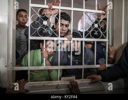 GRAPHIC CONTENT: Maghazi refugee camp, central Gaza Strip, 12 January 2018. Mourners attend the funeral of 16-year old Amir Abu Musaed in the The teenager was shot during clashes between Palestinians and Israeli forces along the Gaza border on Thursday. Photo: Wissam Nassar/dpa/Alamy Live News Stock Photo