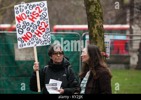 London, UK. 12th January, 2018. Local residents and environmental campaigners protest against the planned felling of mature London Plane, Red Oak, Common Lime, Common Whitebeam and Wild Service trees in Euston Square Gardens to make way for temporary sites for construction vehicles and a displaced taxi rank as part of preparations for the HS2 rail line. Stock Photo