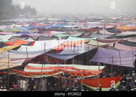 Tongi, Bangladesh. 12th Jan, 2018. Muslim devotees gather near the tented accommodations to offer Friday prayers on the first day of the Biswa Ijtema or World Muslims Congregation on the banks of River Turag in Tongi, outside of Dhaka, Bangladesh. Credit: Suvra Kanti Das/ZUMA Wire/Alamy Live News Stock Photo