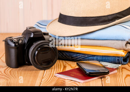 the most necessary things are ready for a long journey, close-up on a wooden table Stock Photo