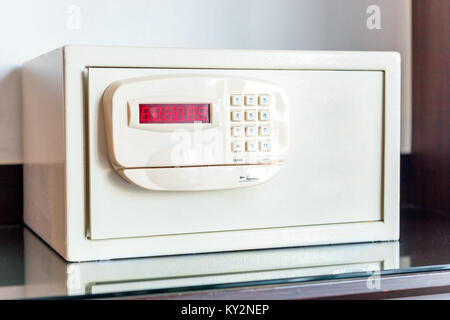 white small safe with coded lock on the table in the hotel close-up Stock Photo